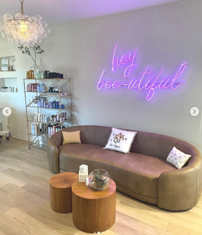 Lounge with the hey bee-utiful neon sign